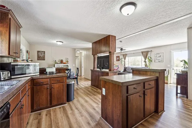 a kitchen with stainless steel appliances granite countertop a sink a stove and a refrigerator