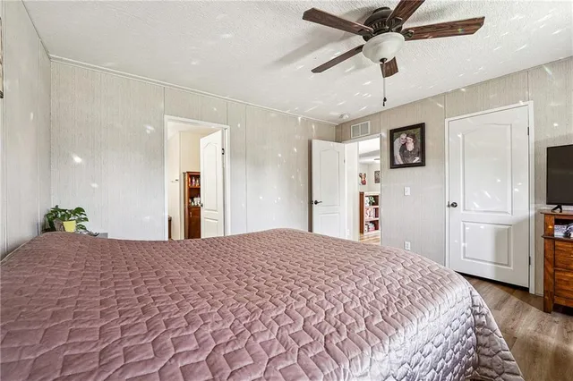 a bedroom with a bed and a chandelier