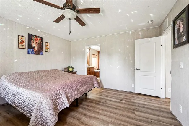 a bedroom with bed and a chandelier