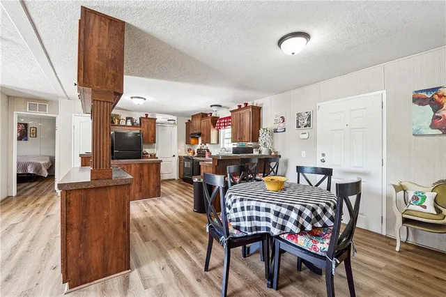 a outdoor dining space with furniture and wooden floor