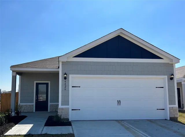 a bathroom with a sink toilet vanity and shower