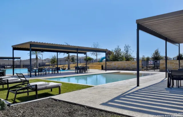 a swimming pool with outdoor seating