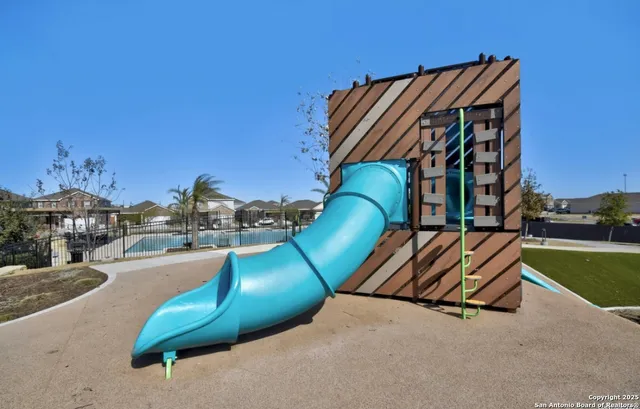 swimming pool with outdoor seating and plants