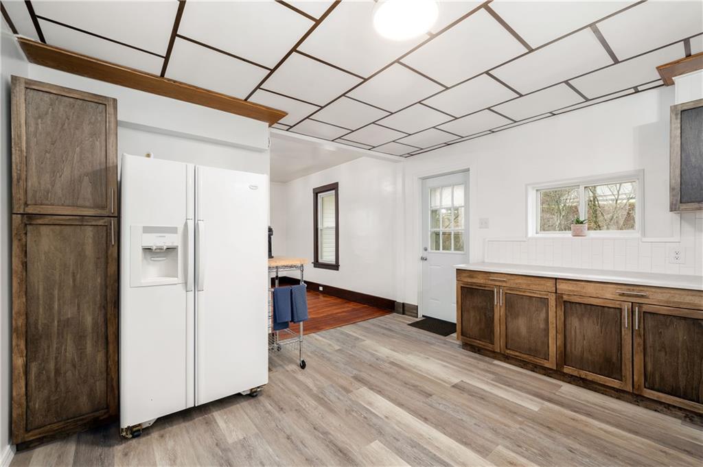 140 Whitestown Road Lyndora, PA 16045 - Photo 13 of 29 a large white kitchen with wooden floor and entryway