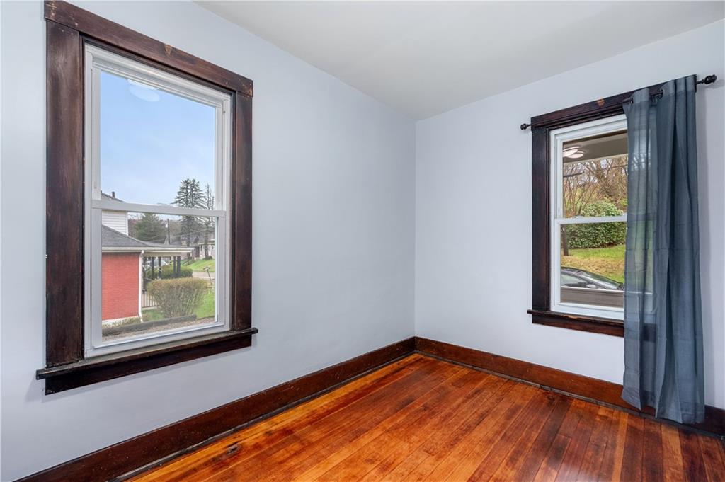 140 Whitestown Road Lyndora, PA 16045 - Photo 14 of 29 a view of an empty room with a window and wooden floor