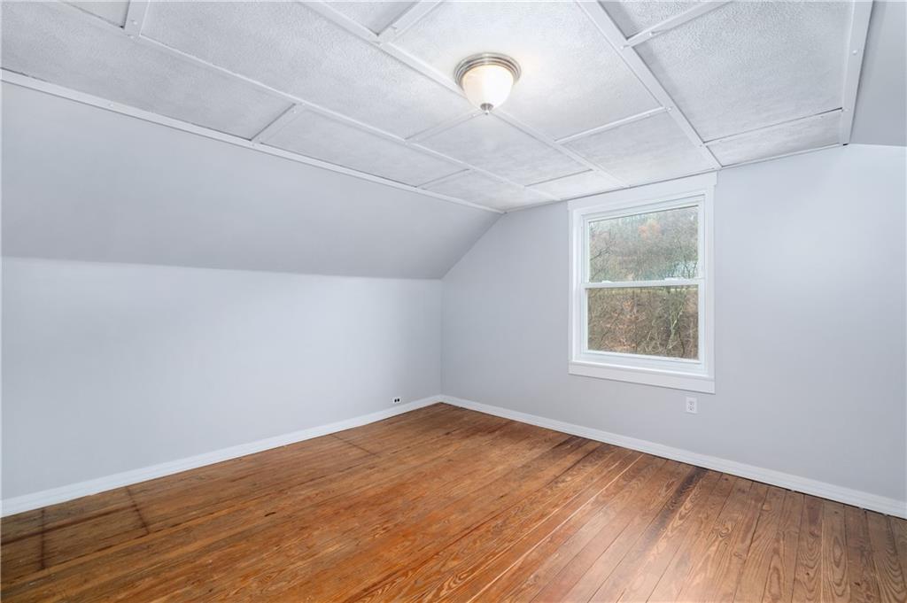 140 Whitestown Road Lyndora, PA 16045 - Photo 16 of 29 an empty room with wooden floor and windows