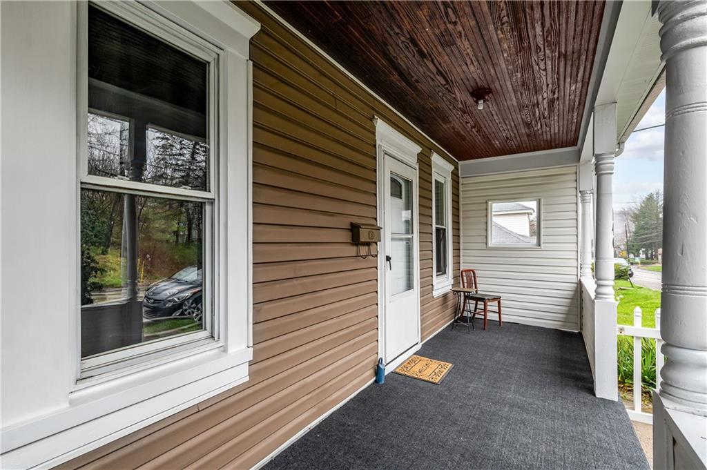 140 Whitestown Road Lyndora, PA 16045 - Photo 3 of 29 a view of a porch with wooden floor and a fireplace