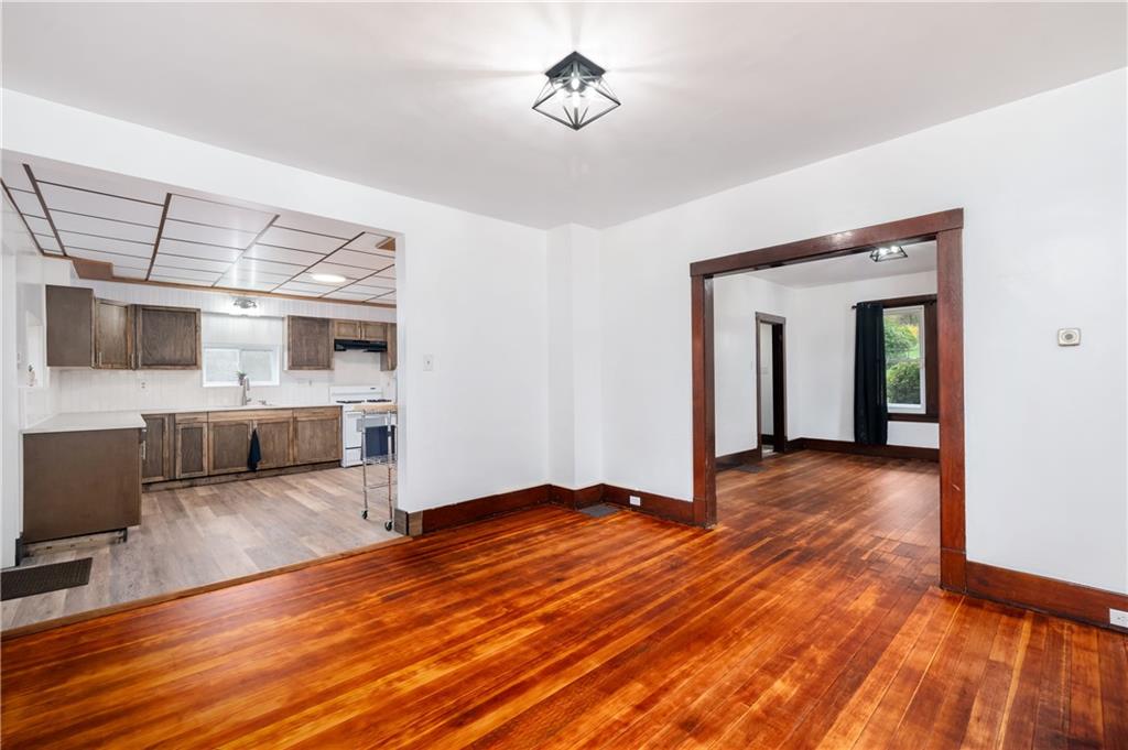 140 Whitestown Road Lyndora, PA 16045 - Photo 9 of 29 a view of a livingroom with wooden floor and a kitchen