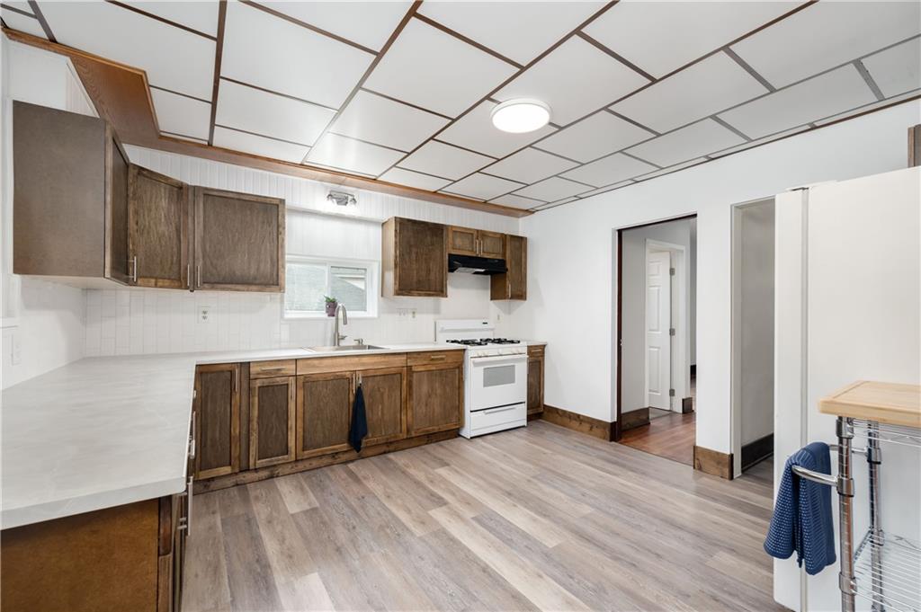 140 Whitestown Road Lyndora, PA 16045 - Photo 10 of 29 a large kitchen with kitchen island granite countertop wooden floors and a sink