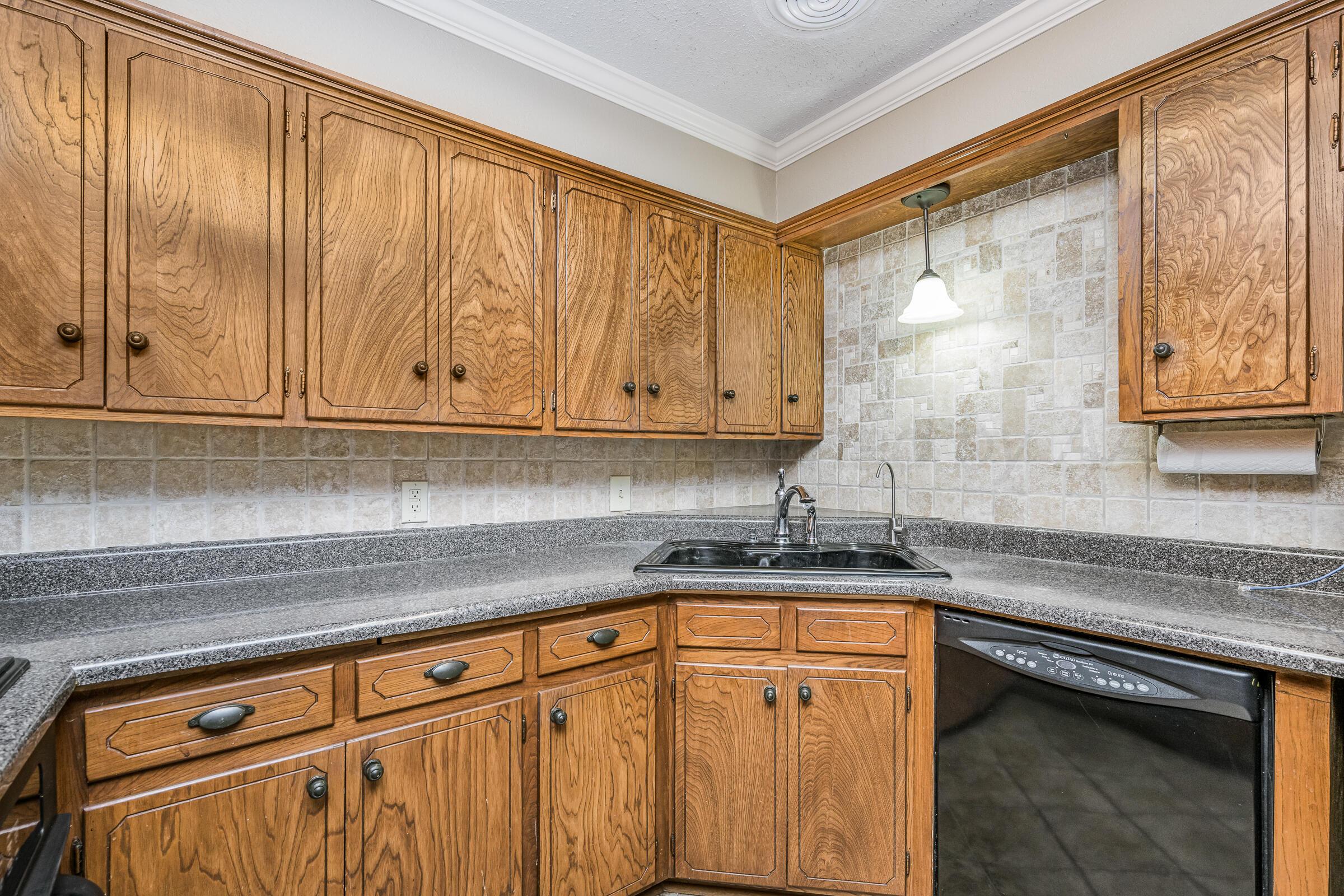 4400 West Farmers Avenue Amarillo, TX 79110 - Photo 12 of 27 a kitchen with stainless steel appliances granite countertop a sink a stove and dishwasher with cabinets
