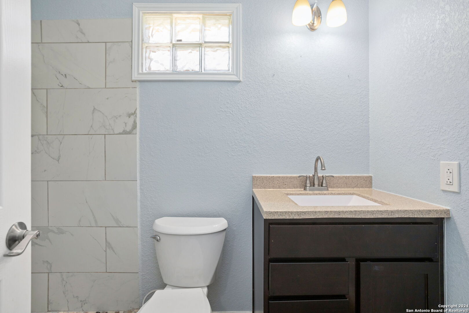 113 Vista Road San Antonio, TX 78210 - Photo 12 of 17 a bathroom with a sink toilet and a mirror