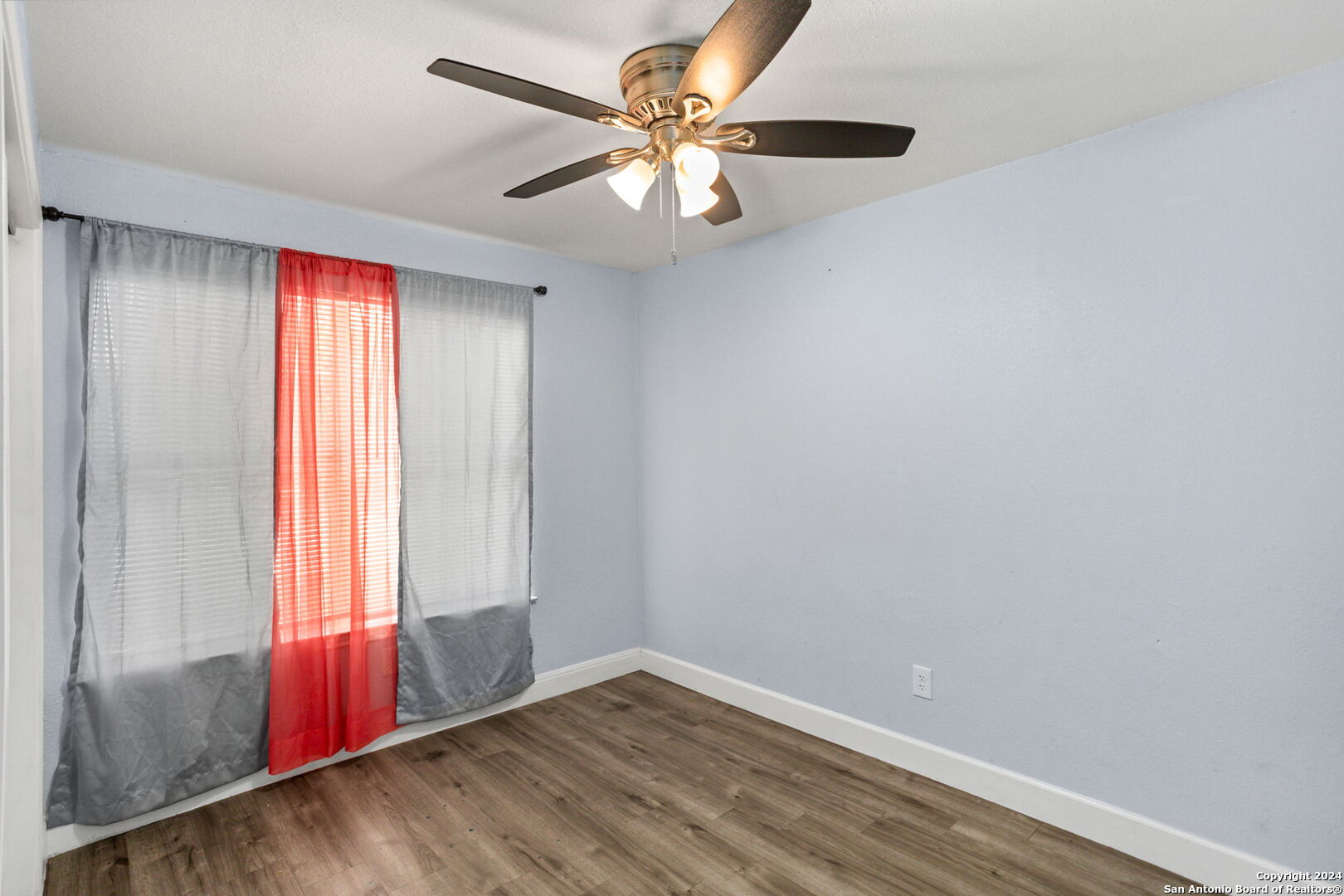 113 Vista Road San Antonio, TX 78210 - Photo 13 of 17 an empty room with windows and fan