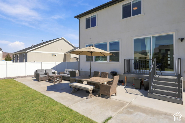 7939 Seattle Slew Road Eagle Mountain, UT 84005 - Photo 46 of 52 Rear exterior featuring a concrete patio, a raised deck with stairs, and a sliding glass door