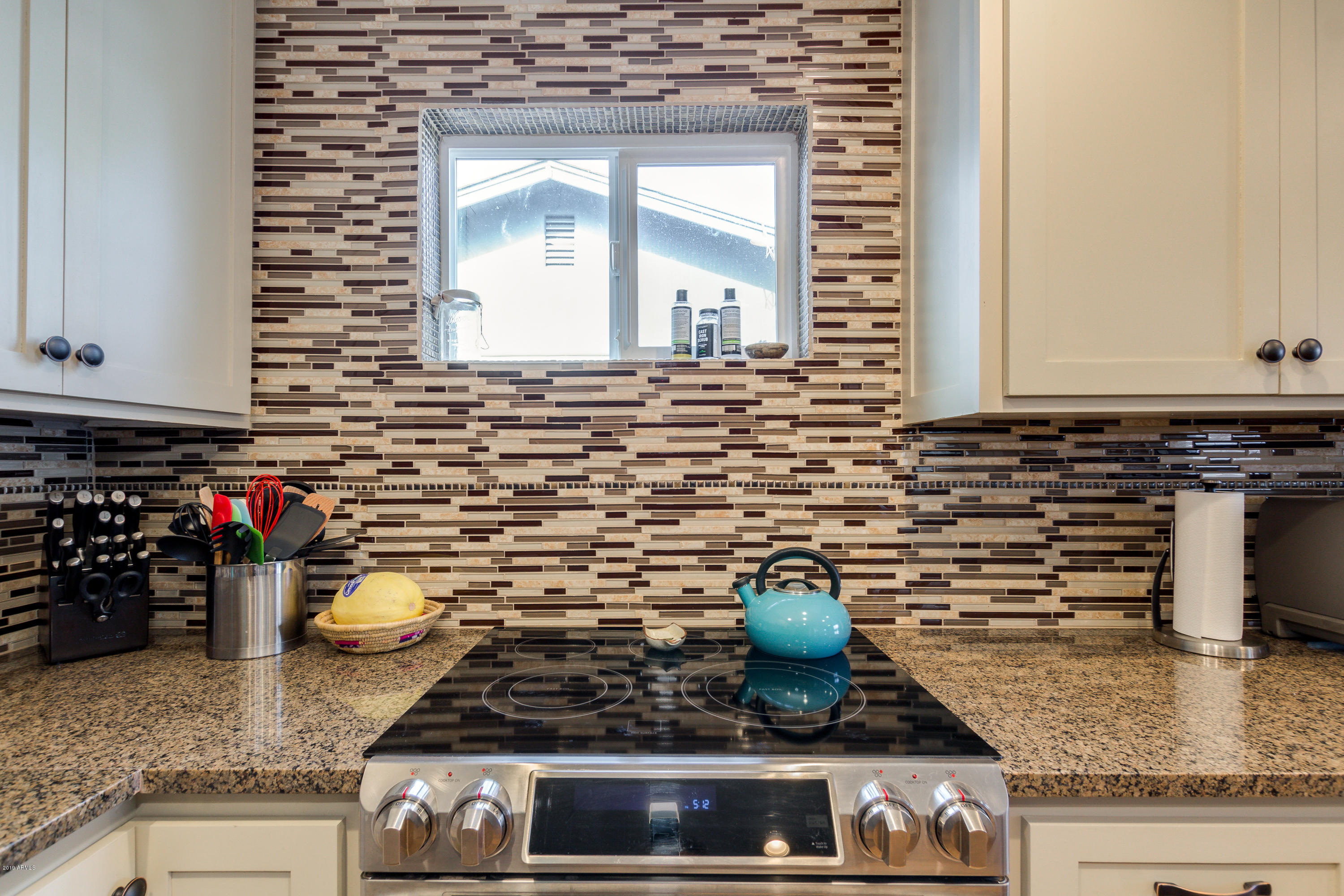 3021 West Bloomfield Road Phoenix, AZ 85029 - Photo 13 of 27 a kitchen with a stove and cabinets