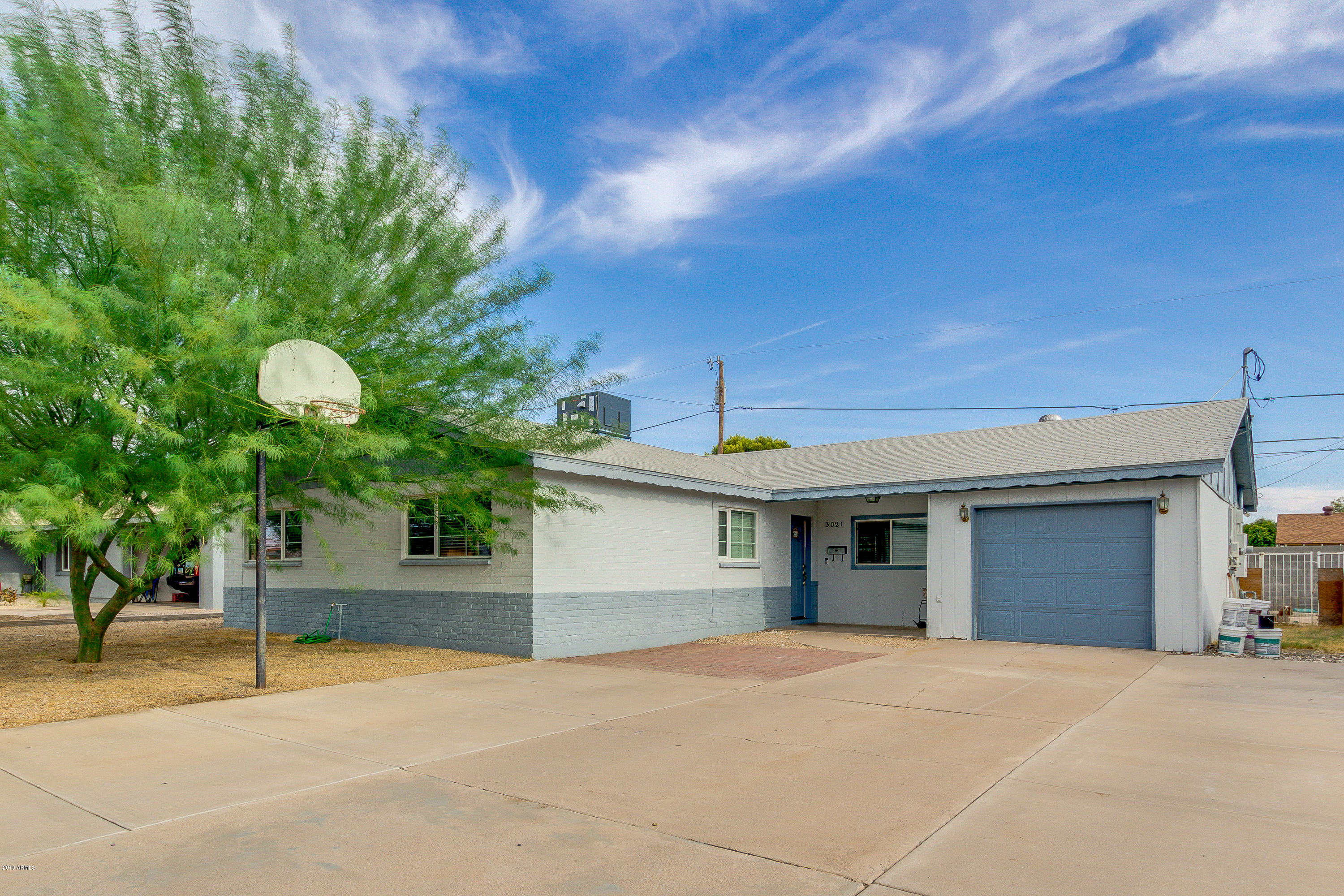 3021 West Bloomfield Road Phoenix, AZ 85029 - Photo 4 of 27 a front view of a house with a yard and garage