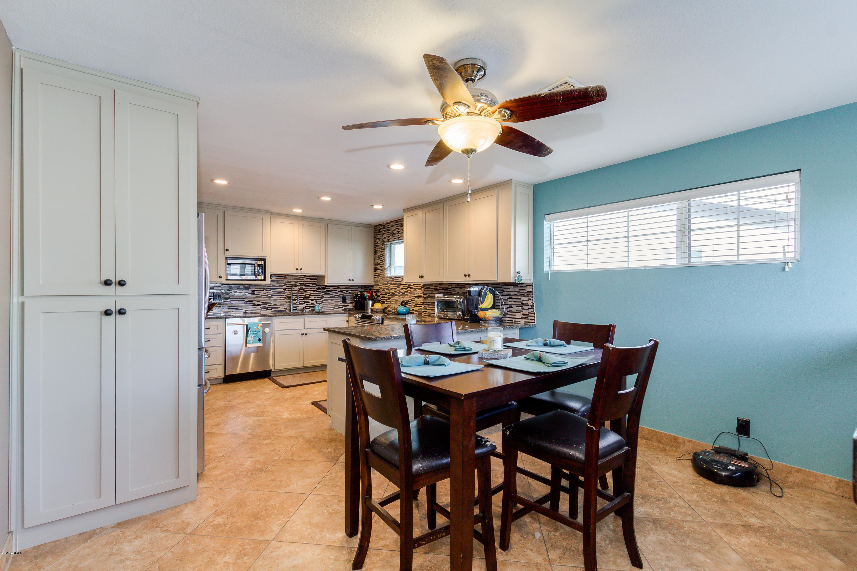 3021 West Bloomfield Road Phoenix, AZ 85029 - Photo 10 of 27 a dining room with a wooden table and chairs