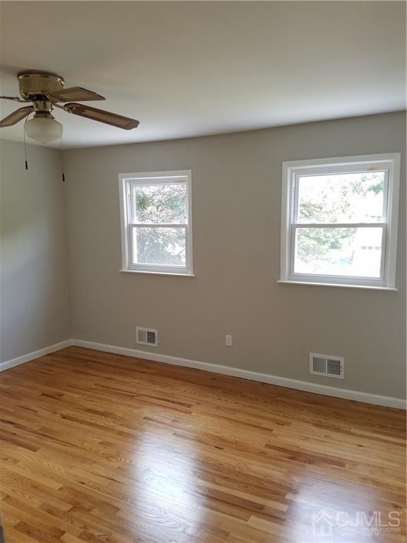 19 Kingsbridge Road Somerset, NJ 08873 - Photo 10 of 23 a view of an empty room with wooden floor and a window