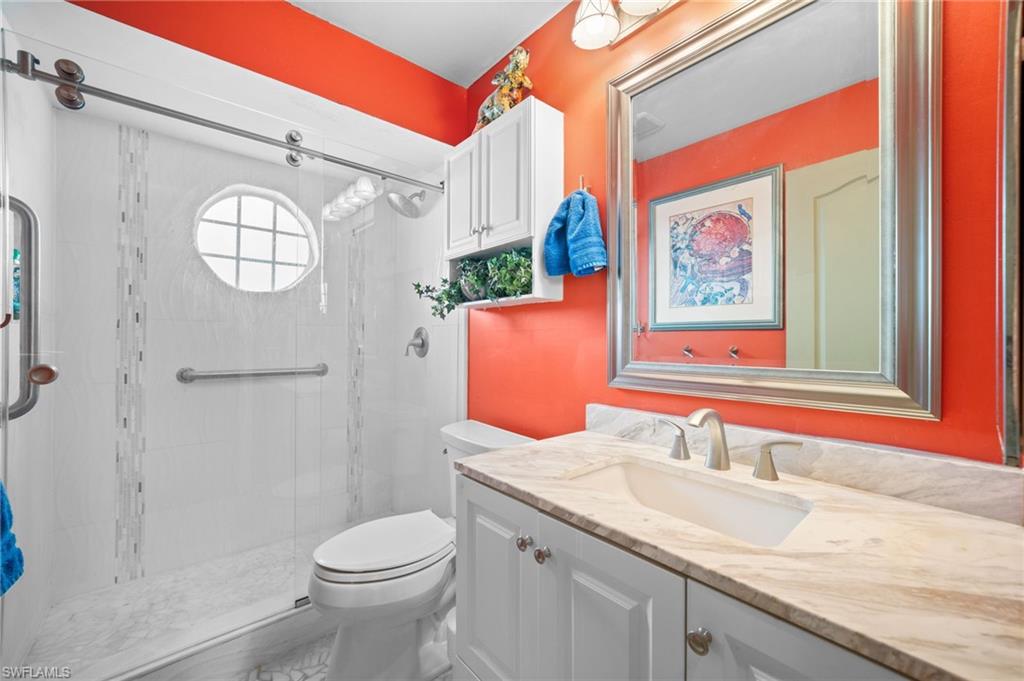 256 Countryside Drive Naples, FL 34104 - Photo 21 of 40 Full bathroom with vanity and a shower stall