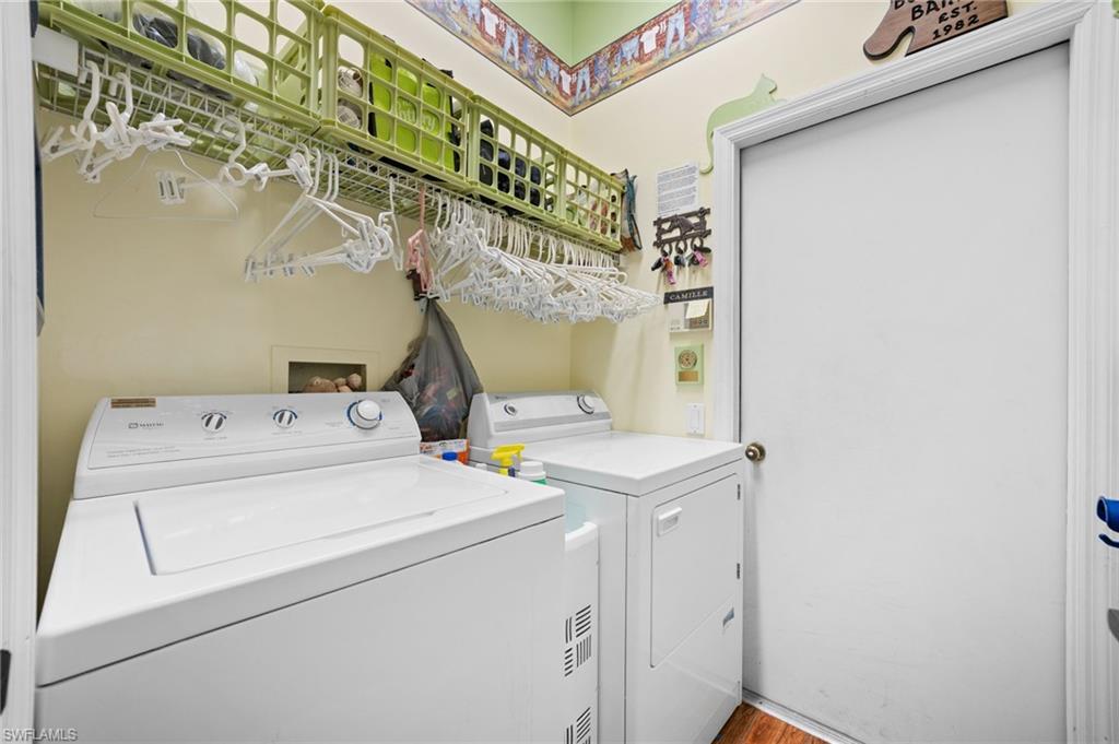256 Countryside Drive Naples, FL 34104 - Photo 23 of 40 Laundry room with independent washer and dryer and light wood-style floors