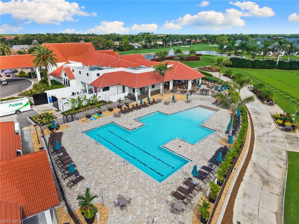 256 Countryside Drive Naples, FL 34104 - Photo 32 of 40 Community pool featuring a patio, a water view, and view of golf course