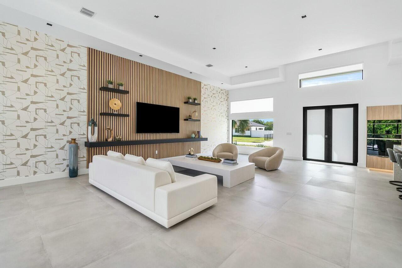 751 Pelican Way North Palm Beach, FL 33408 - Photo 12 of 39 a living room with furniture and a flat screen tv