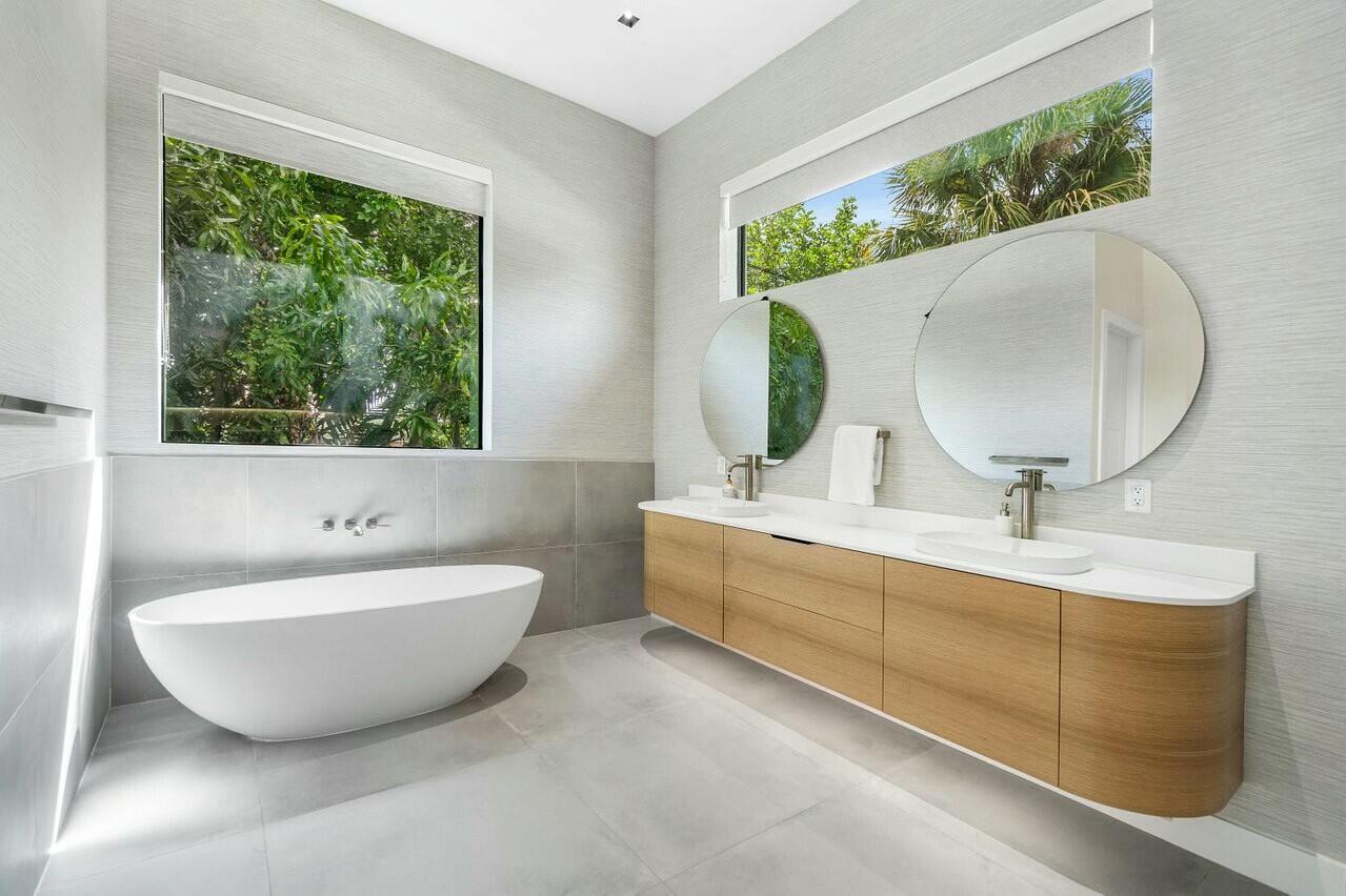 751 Pelican Way North Palm Beach, FL 33408 - Photo 22 of 39 a bathroom with a sink mirror and a bathtub