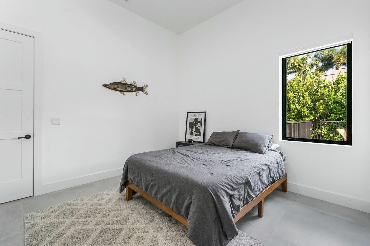 751 Pelican Way North Palm Beach, FL 33408 - Photo 27 of 39 a bedroom with a bed and window