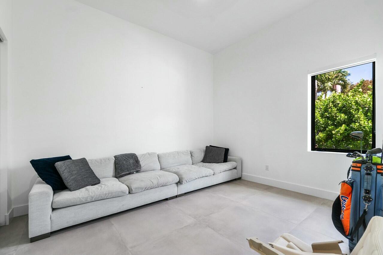 751 Pelican Way North Palm Beach, FL 33408 - Photo 30 of 39 a living room with furniture and a flat screen tv