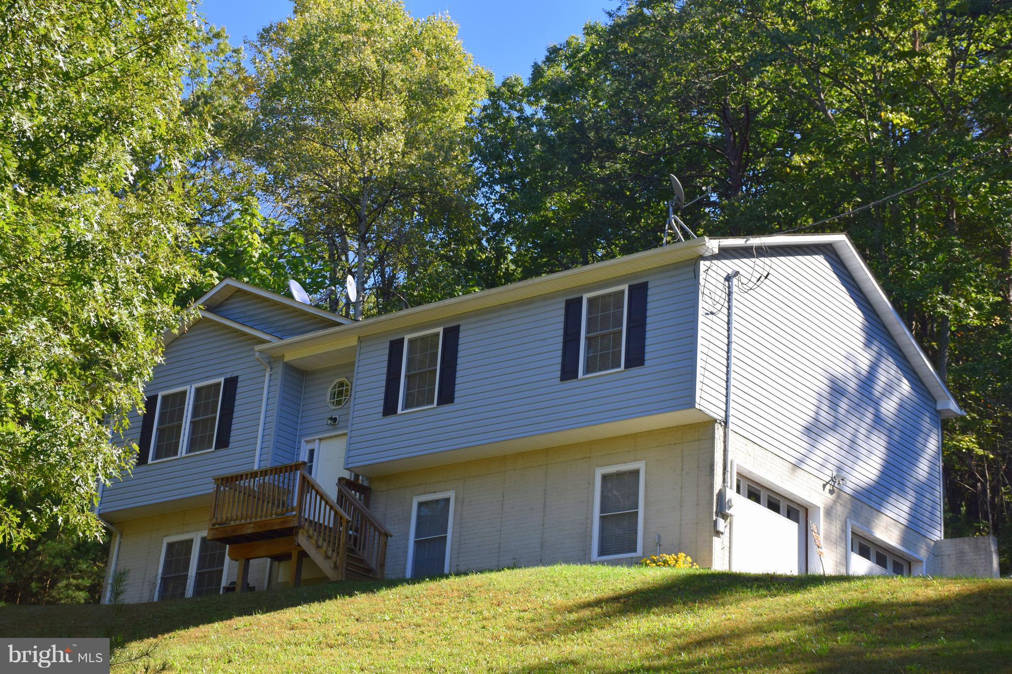 250 Spring Hollow Road Front Royal, VA 22630 - Photo 1 of 30 a front view of a house with a garden