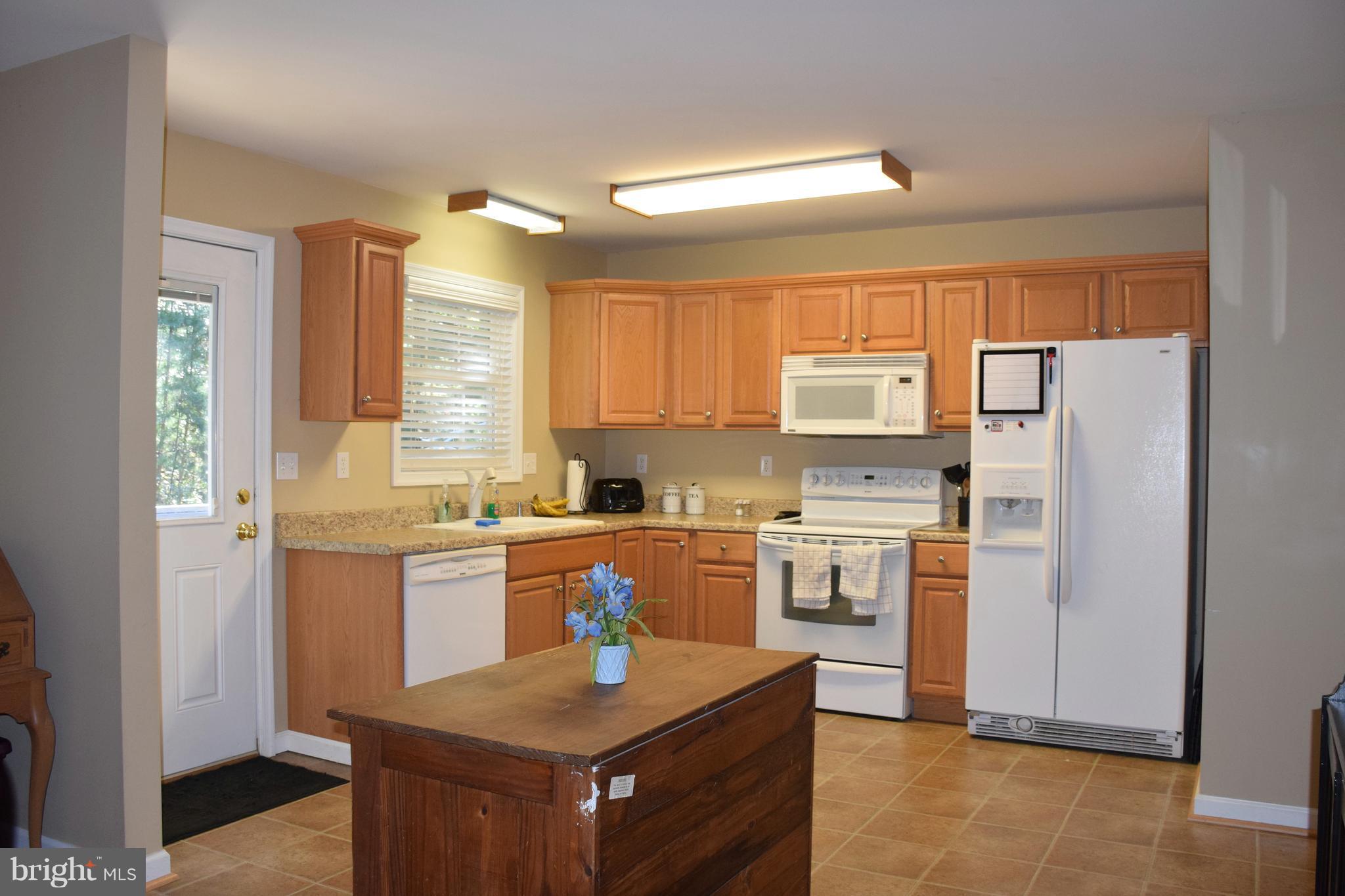 250 Spring Hollow Road Front Royal, VA 22630 - Photo 4 of 30 a kitchen with white cabinets and stainless steel appliances