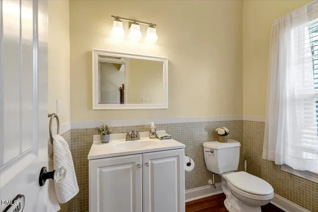 a bathroom with a sink toilet and window