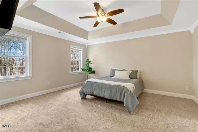 a spacious bedroom with a bed and a window