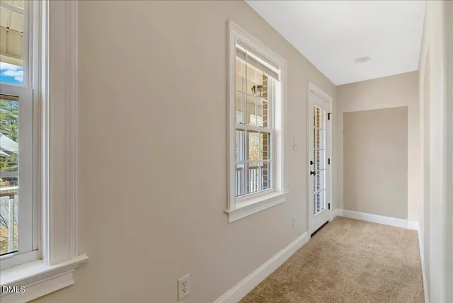 a view of empty room with windows