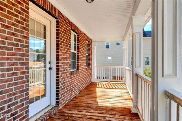 a view of a balcony with wooden floor