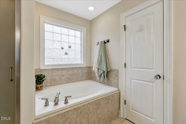 a bath tub sitting next to a window