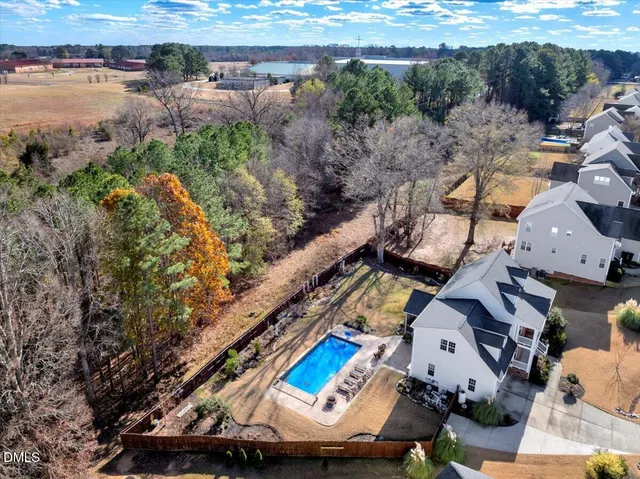 an aerial view of a house with a yard basket ball court and outdoor seating