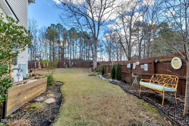 a backyard of a house with barbeque oven table and chairs