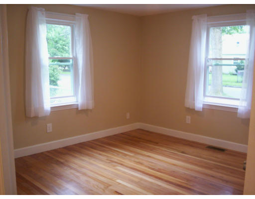 17 Bessemer Street Springfield, MA 01104 - Photo 16 of 30 an empty room with wooden floor and windows