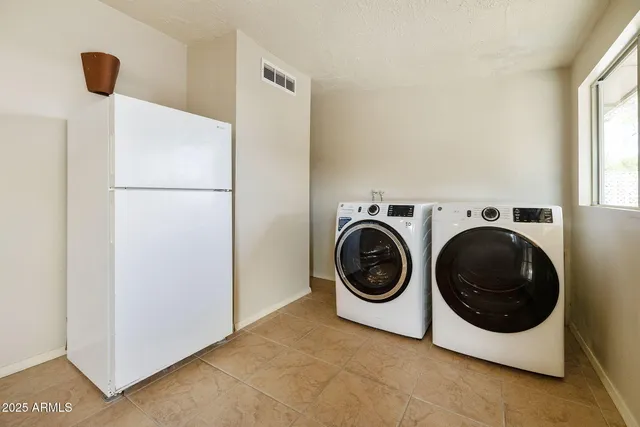 a view of a hallway with wooden floor and a living room