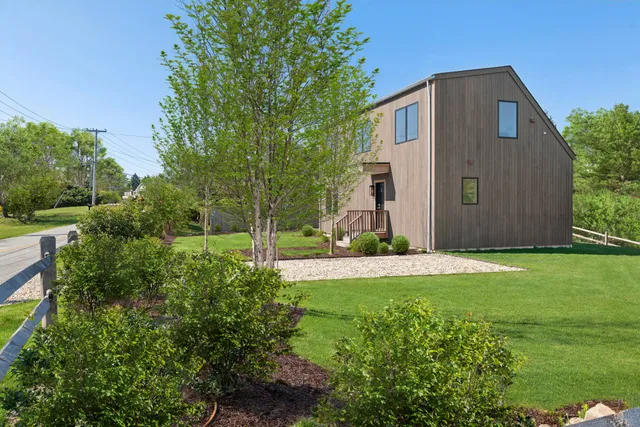 a front view of house with yard and green space