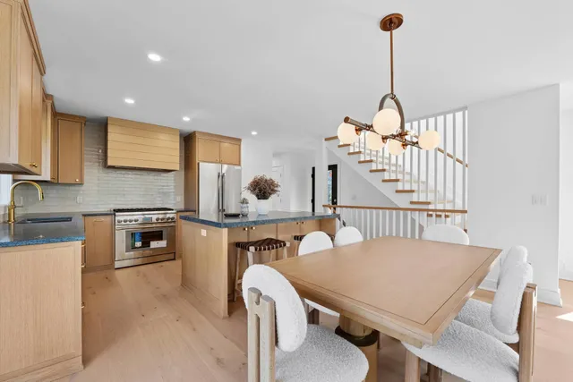a view of a kitchen with a table and chairs