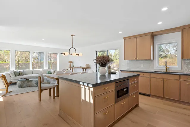 a kitchen with stainless steel appliances granite countertop a sink and a stove