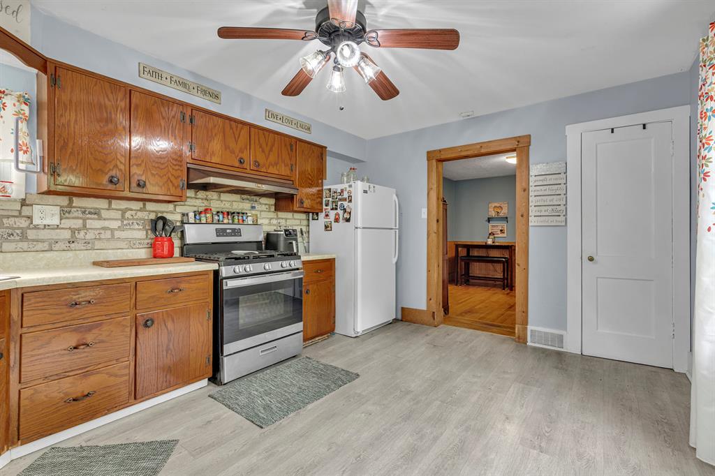 195 Highway 68 Rochester, PA 15074 - Photo 9 of 25 a kitchen with a stove a sink and a refrigerator