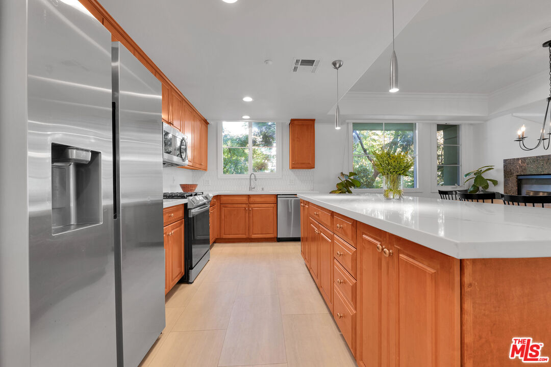 1601 South Bentley Avenue, Unit 201 Los Angeles, CA 90025 - Photo 11 of 39 a kitchen with stainless steel appliances a sink and a refrigerator