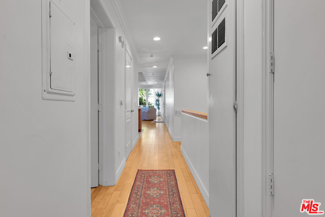 1601 South Bentley Avenue, Unit 201 Los Angeles, CA 90025 - Photo 14 of 39 a view of a hallway with wooden floor and a living room