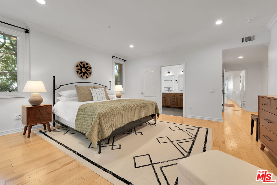 1601 South Bentley Avenue, Unit 201 Los Angeles, CA 90025 - Photo 16 of 39 a bedroom with a bed and wooden floor