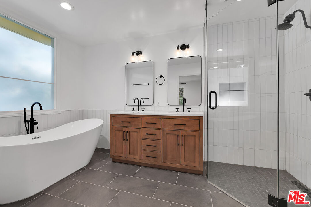 1601 South Bentley Avenue, Unit 201 Los Angeles, CA 90025 - Photo 20 of 39 a spacious bathroom with a double vanity sink mirror and bathtub