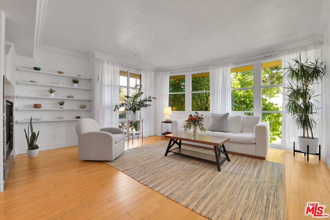 1601 South Bentley Avenue, Unit 201 Los Angeles, CA 90025 - Photo 2 of 39 a living room with furniture and a large window