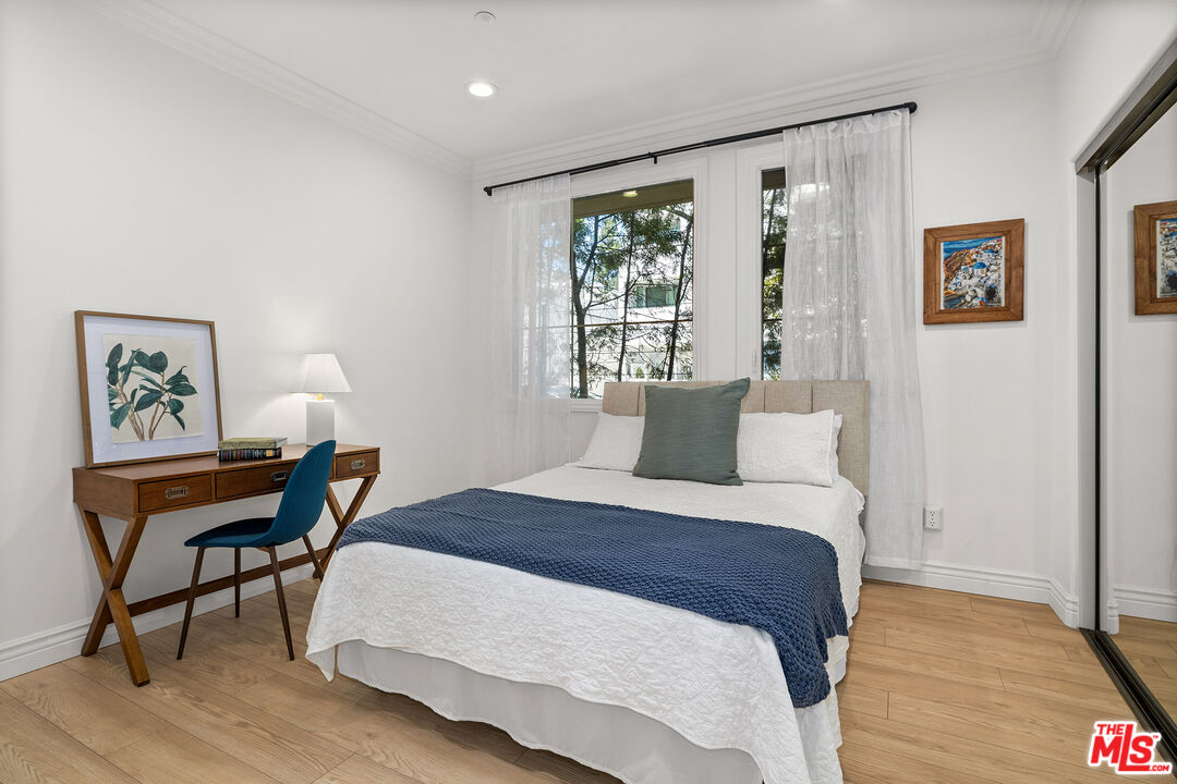 1601 South Bentley Avenue, Unit 201 Los Angeles, CA 90025 - Photo 24 of 39 a bedroom with a bed table and a window