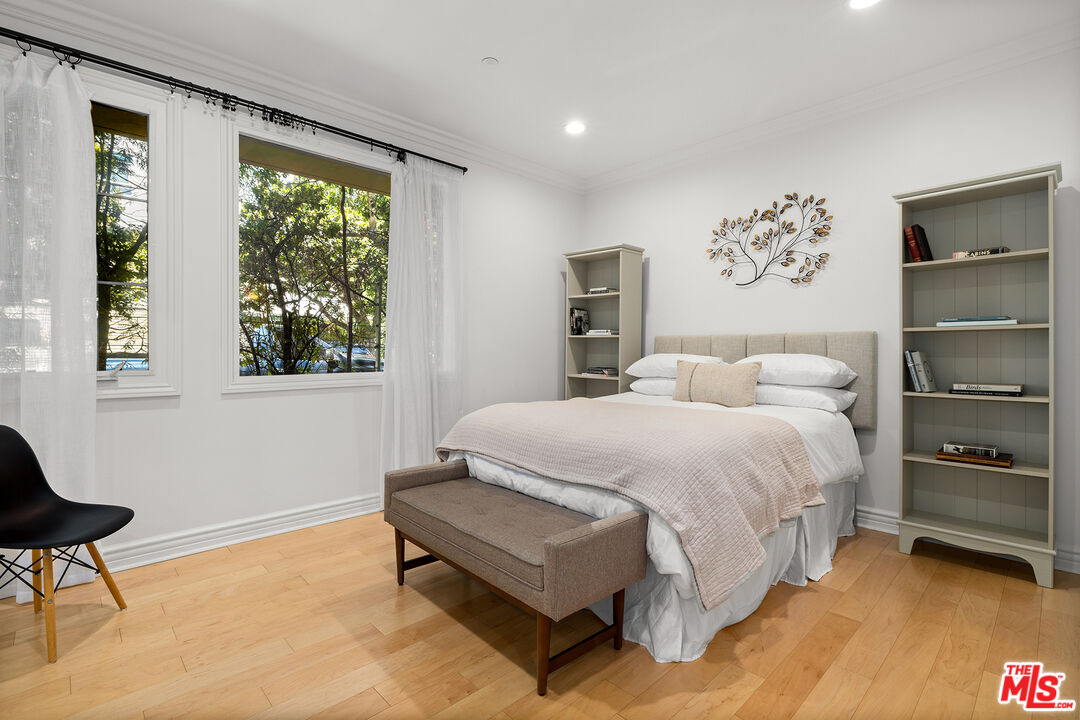 1601 South Bentley Avenue, Unit 201 Los Angeles, CA 90025 - Photo 25 of 39 a spacious bedroom with a bed and chair